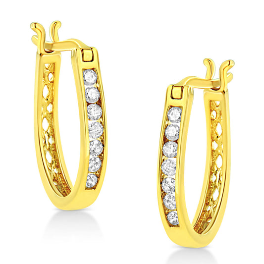 Pair of yellow metal hoop earrings with channel-set round white gemstones, shown in a close-up side angle.