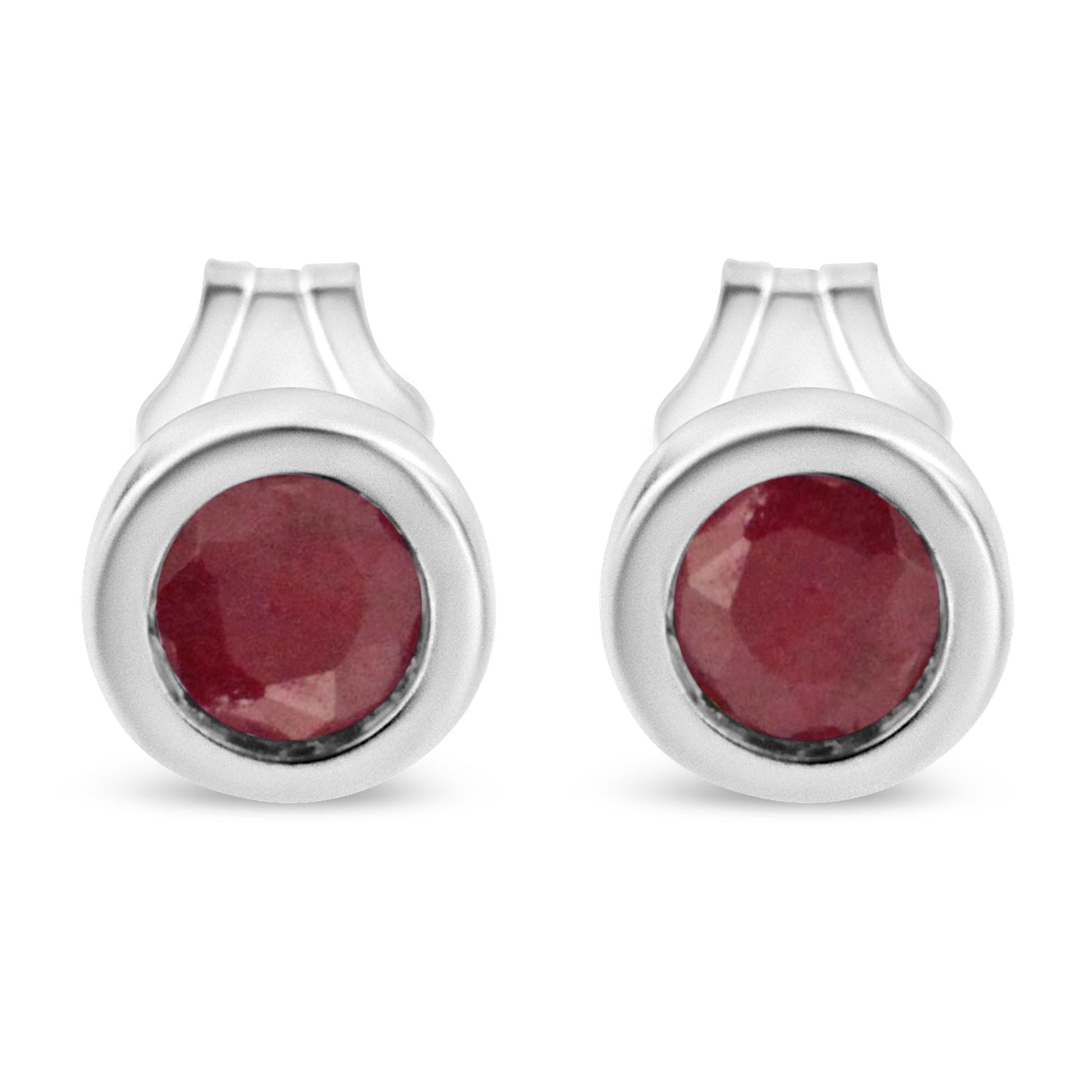 Front view of white metal round bezel-set red gemstone earrings.