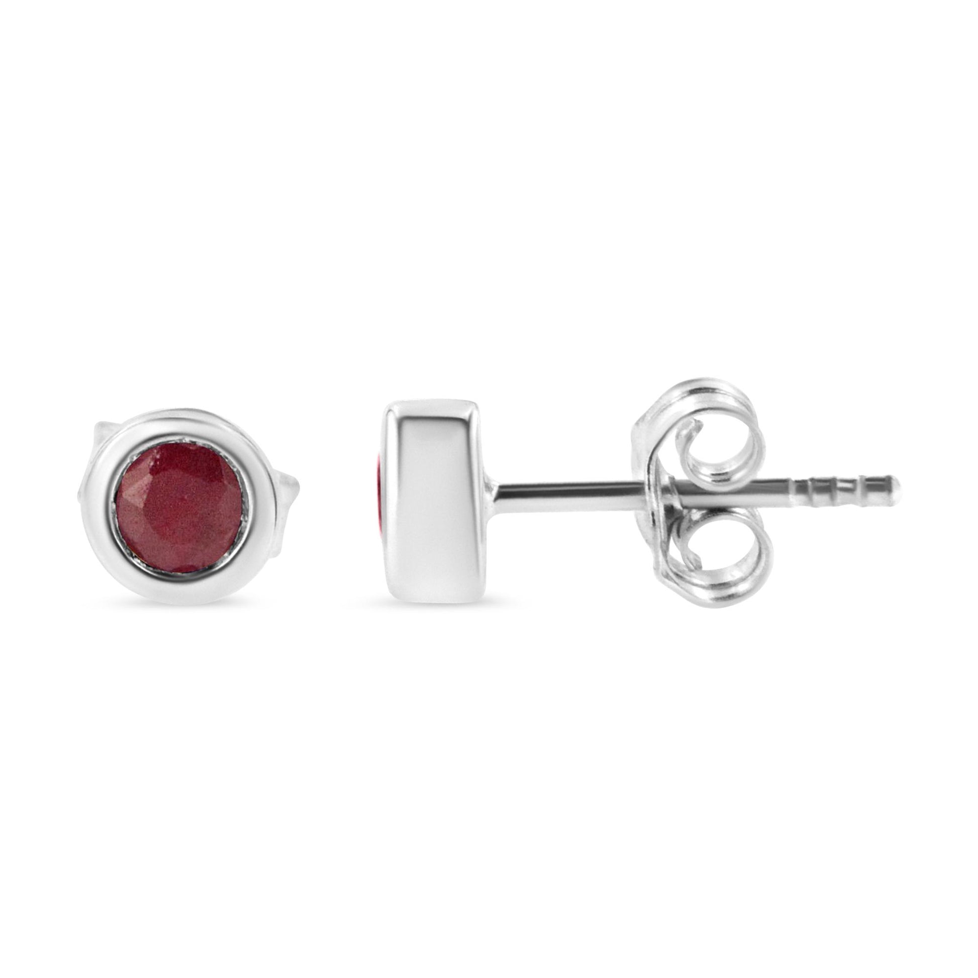 Front and side view of white metal stud earrings with round red gemstones in bezel setting.