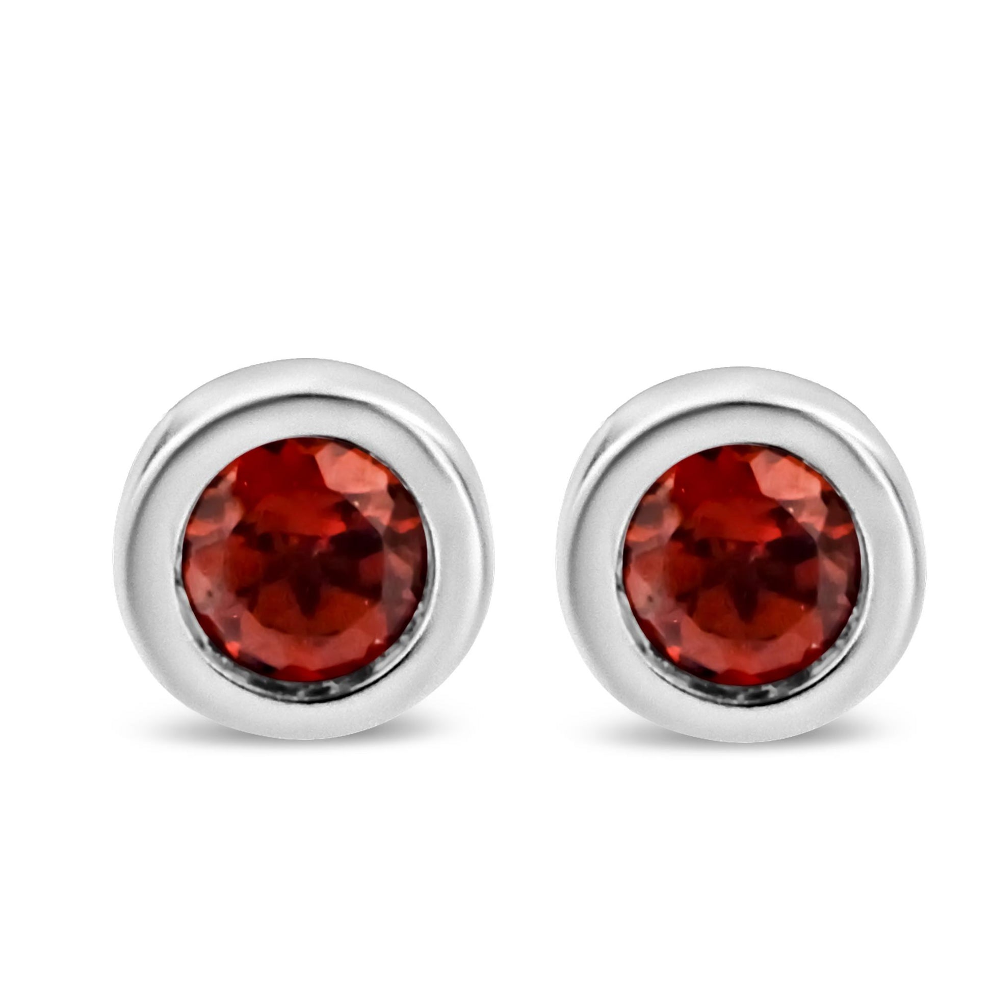 Front view of round white metal stud earrings with red gemstones in bezel settings.