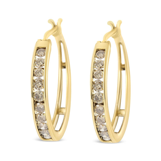 Front-facing view of yellow metal hoop earrings set with multiple round champagne-colored gemstones in prong settings.