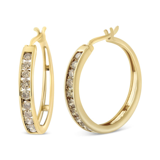 Close-up front and side view of yellow metal hoop earrings with round prong-set champagne-colored gemstones along the outer edge.