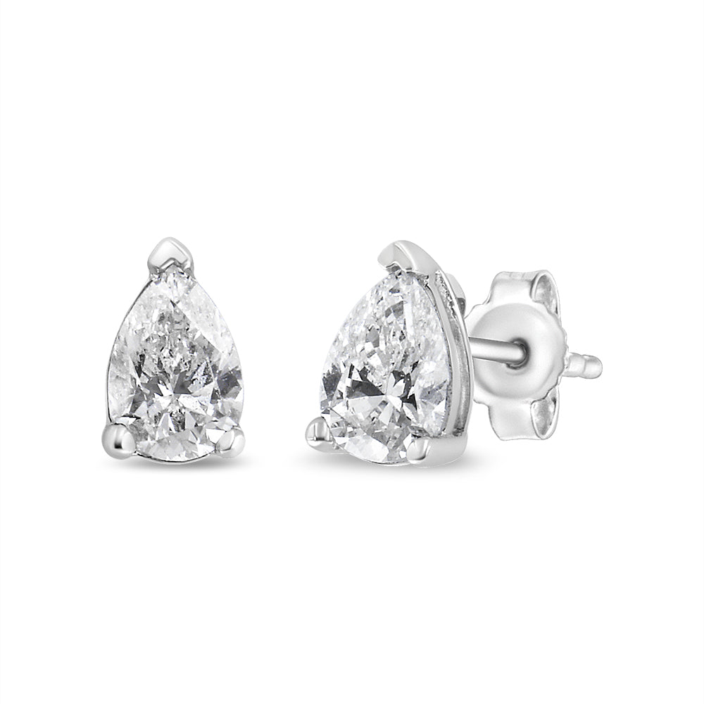 Front angled view of white metal stud earrings featuring pear-shaped white gemstones in 3-prong settings.