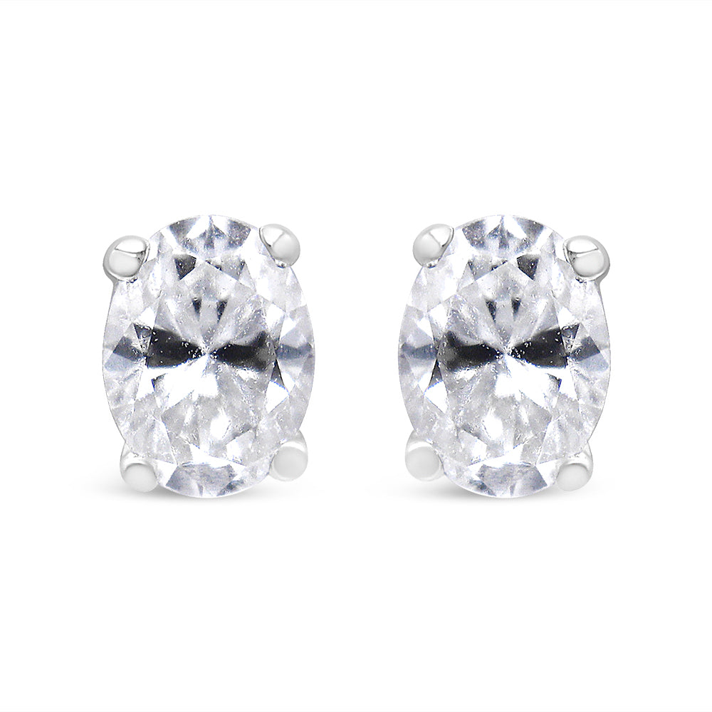 Close-up front view of a pair of white metal stud earrings featuring oval-shaped white gemstones in 4-prong settings.