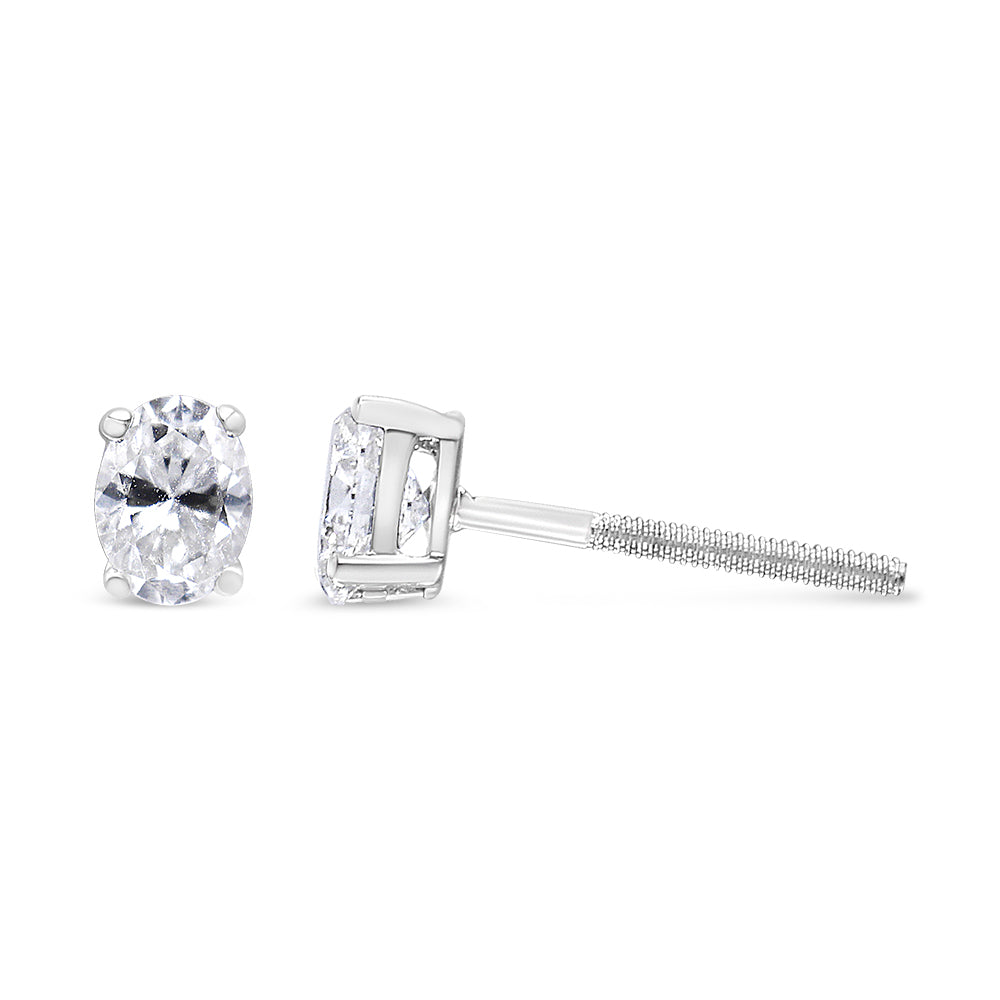 White metal stud earrings with oval white gemstones in four-prong settings, shown from front and side angles.