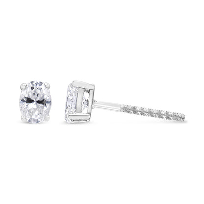 White metal stud earrings with oval white gemstones in four-prong settings, shown from front and side angles.