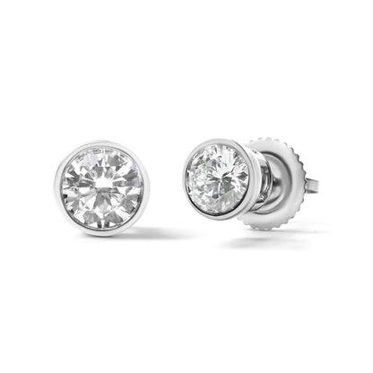 Close-up shot of a pair of white metal bezel-set round white gemstone stud earrings, shown from the front and side angles.