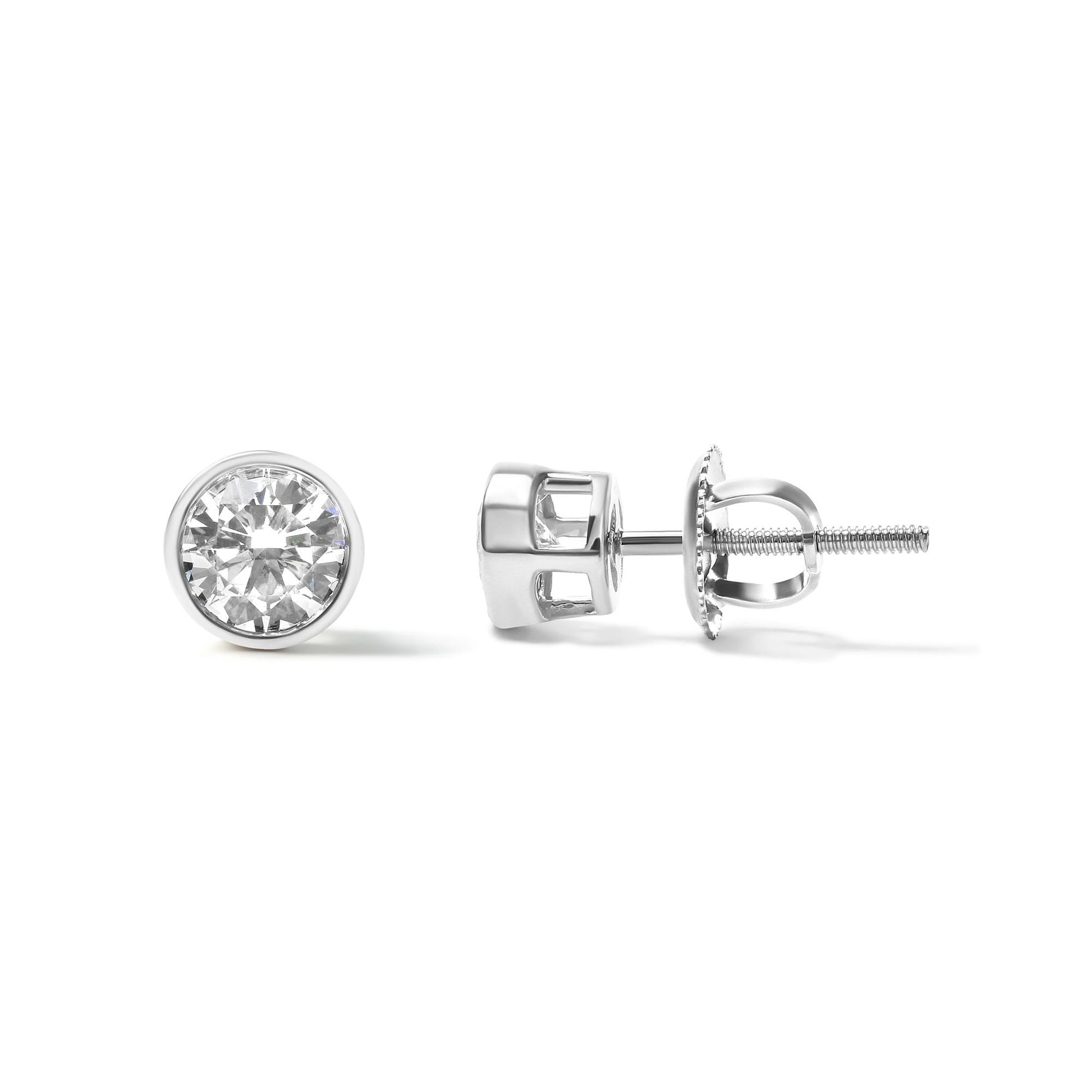 Pair of white metal stud earrings with round white gemstones in bezel settings, one viewed from the front and one from the side on a white background.