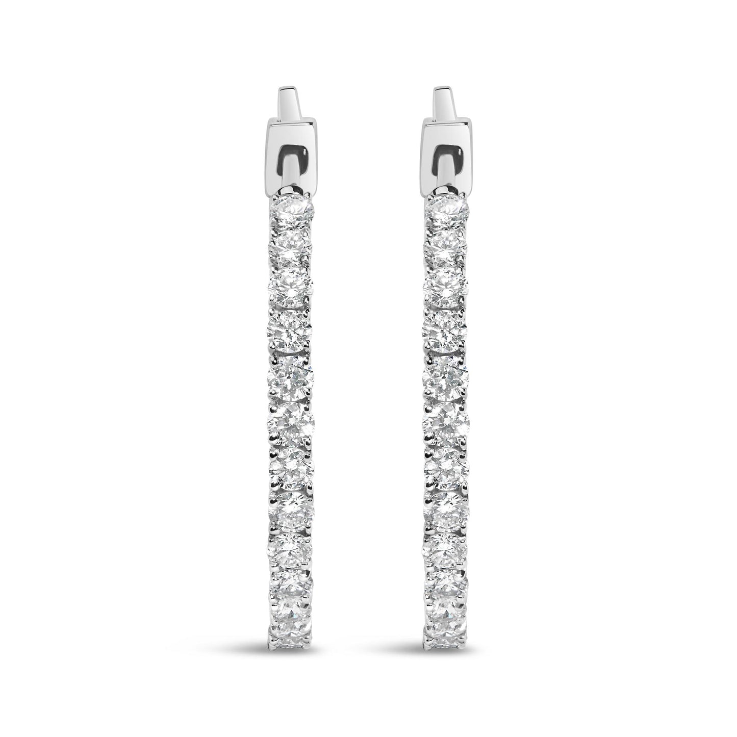 Front-facing view of white metal hoop earrings encrusted with round white gemstones in prong settings.