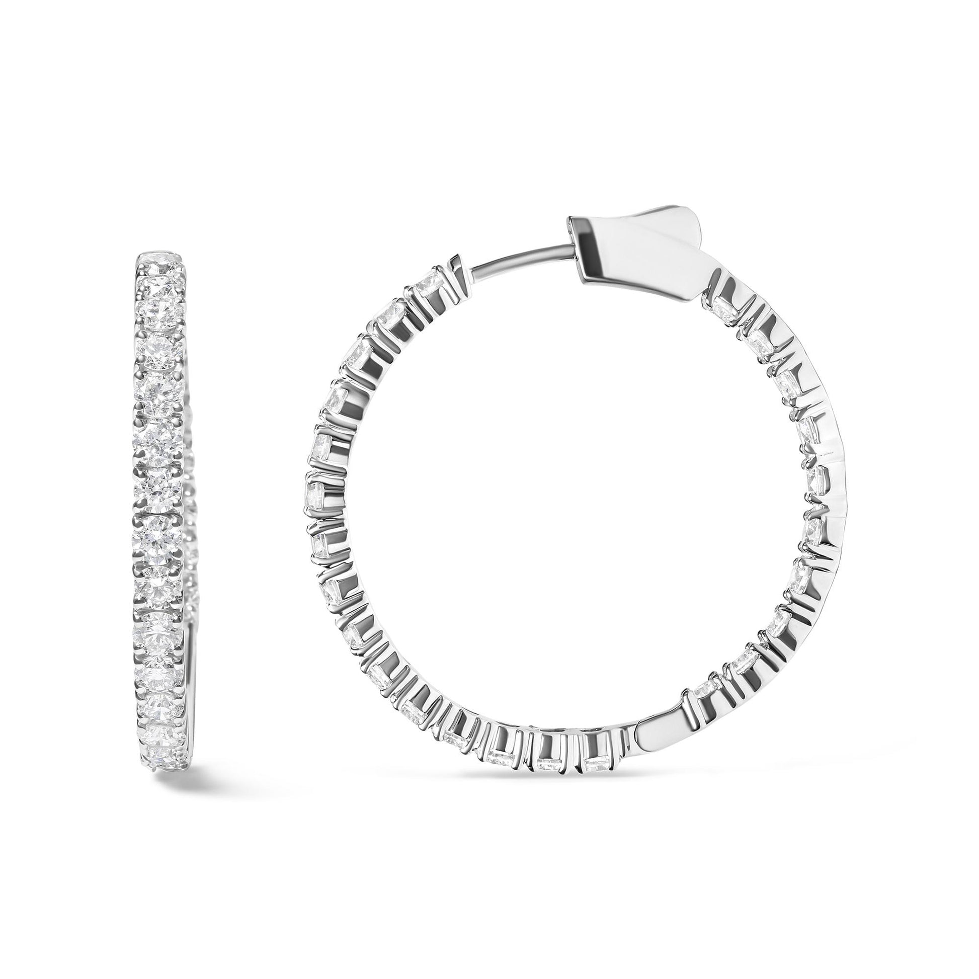 Front and side views of white metal hoop earrings featuring round white gemstones in prong settings along the outer edge.