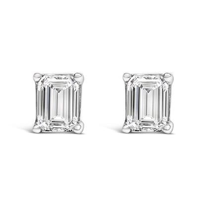 Pair of white metal stud earrings with emerald-shaped white gemstones in a 4-prong setting, shown from the front angle.