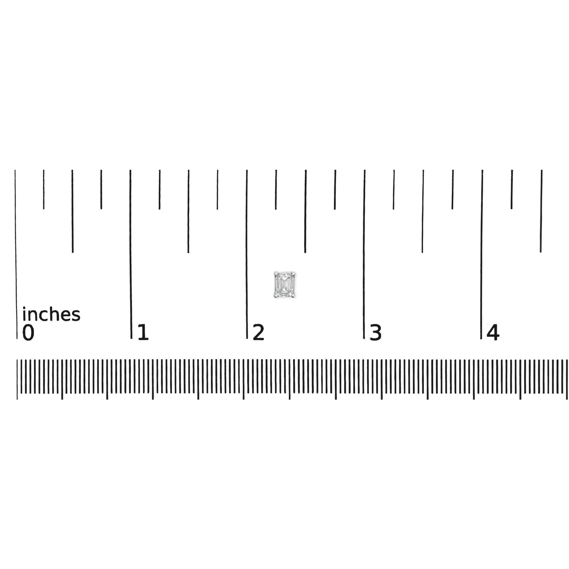 Close-up front view of a single white metal earring featuring an emerald-shaped white gemstone in a 4-prong setting, displayed on a ruler for size reference.