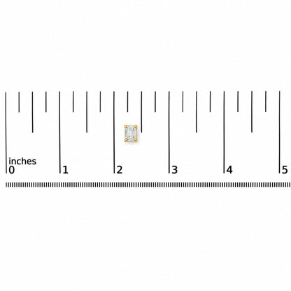 Close-up front view of a single yellow metal earring with an emerald-shaped white gemstone in a four-prong setting, shown on a ruler scale.