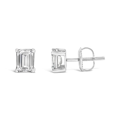 Pair of white metal stud earrings with emerald-shaped white gemstones in four-prong settings, shown from front and side angles on a white background.