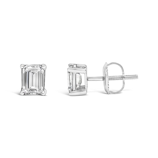 Pair of white metal stud earrings with emerald-shaped white gemstones in four-prong settings, shown from front and side angles on a white background.