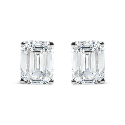 Pair of white metal earrings with emerald shaped white gemstones in 4-prong settings, front facing shot on white background.