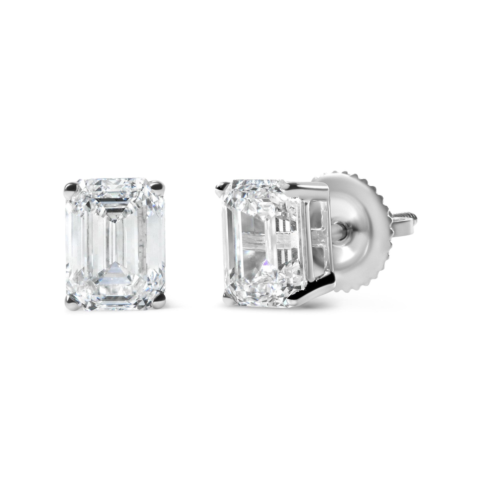 Pair of white metal stud earrings with emerald-shaped white gemstones in 4-prong settings, shown from front and side angles on a white background.