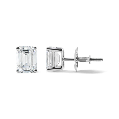 Pair of white metal stud earrings with emerald-shaped white gemstones in a 4-prong setting shown from front and side angles on a white background.