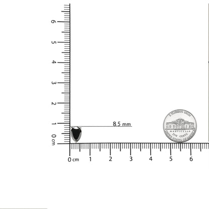 Close-up of pear-shaped black gemstone earring in prong setting on a white metal, shown on a ruler and scale for size reference.