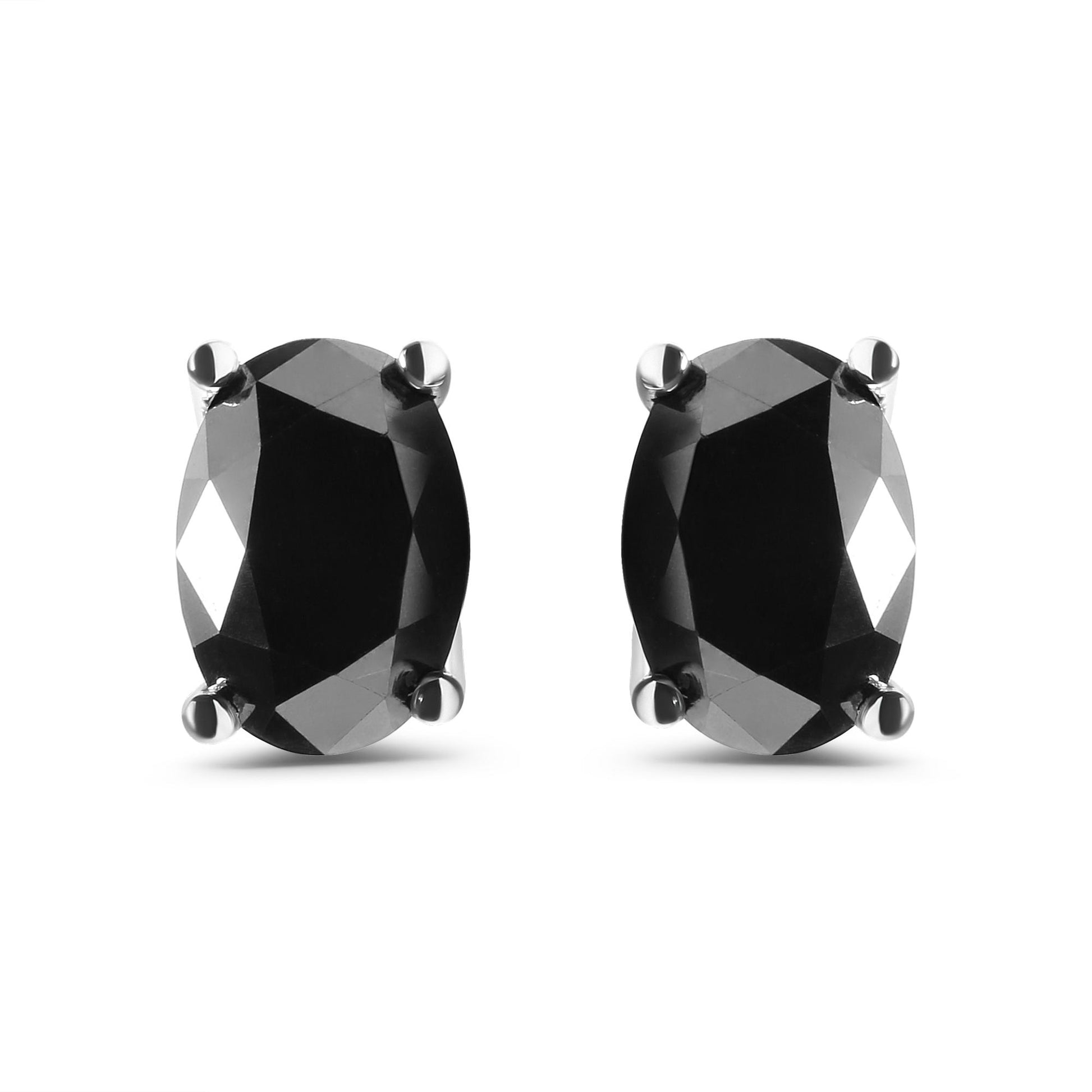 Front-facing close-up of white metal earrings with oval-shaped black gemstones in prong settings.