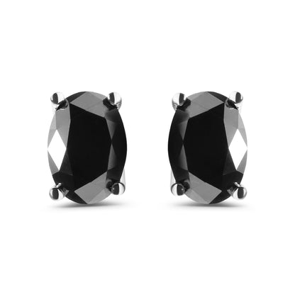 Front-facing close-up of white metal earrings with oval-shaped black gemstones in prong settings.