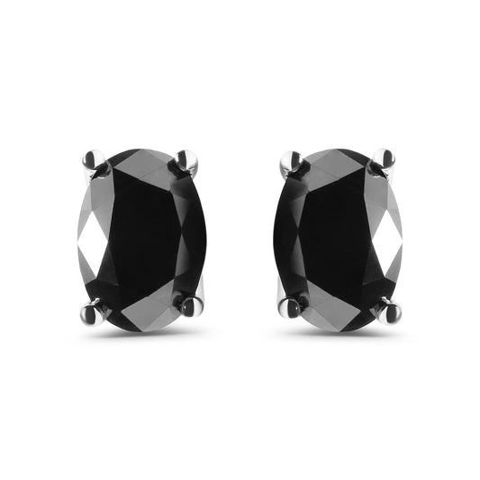 Front-facing close-up of white metal earrings with oval-shaped black gemstones in prong settings.