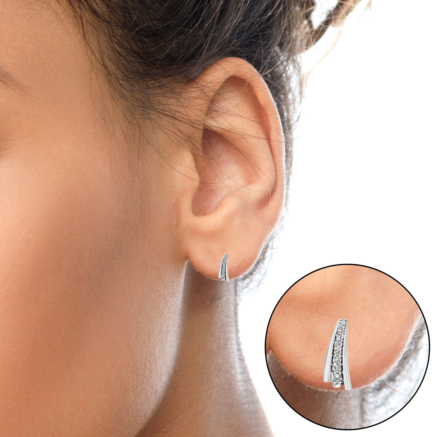 Close-up side view of a white metal earring with a row of round white gemstones in prong settings, worn on a model's ear, with an inset detail of the earring.