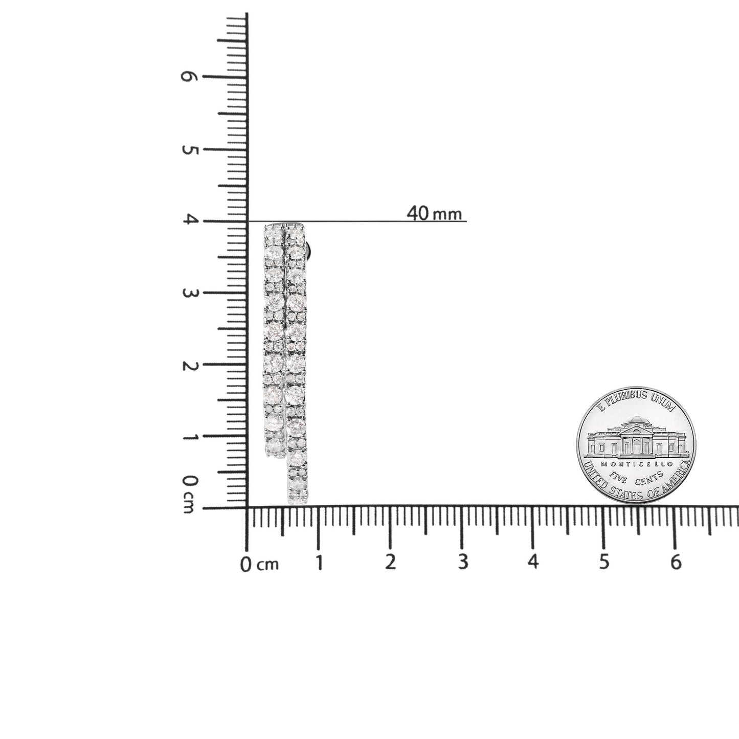Side view of white metal earrings with three rows of round white gemstones in prong settings, shown on a ruler and next to a coin for size reference.
