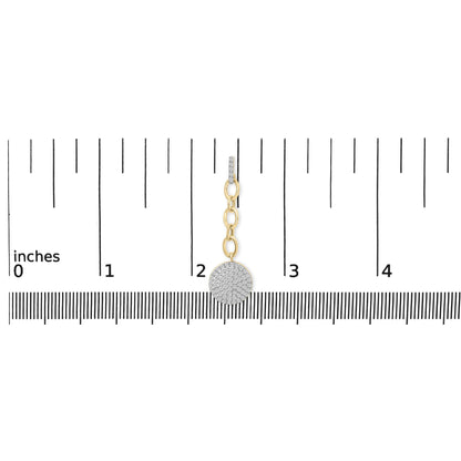 Front view of yellow metal dangle earring with three round linked loops and a circular pendant encrusted with white gemstones, shown on a ruler for size reference.