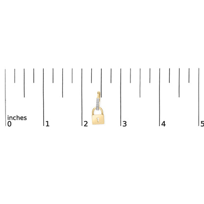 Close-up front view of a yellow metal padlock-shaped earring with a vertical bar adorned with white round prong-set gemstones, placed on a ruler for size reference.