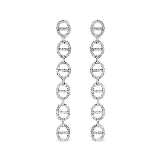 Front view of long white metal earrings composed of linked oval shapes set with round white gemstones in prong settings, shown on white background.