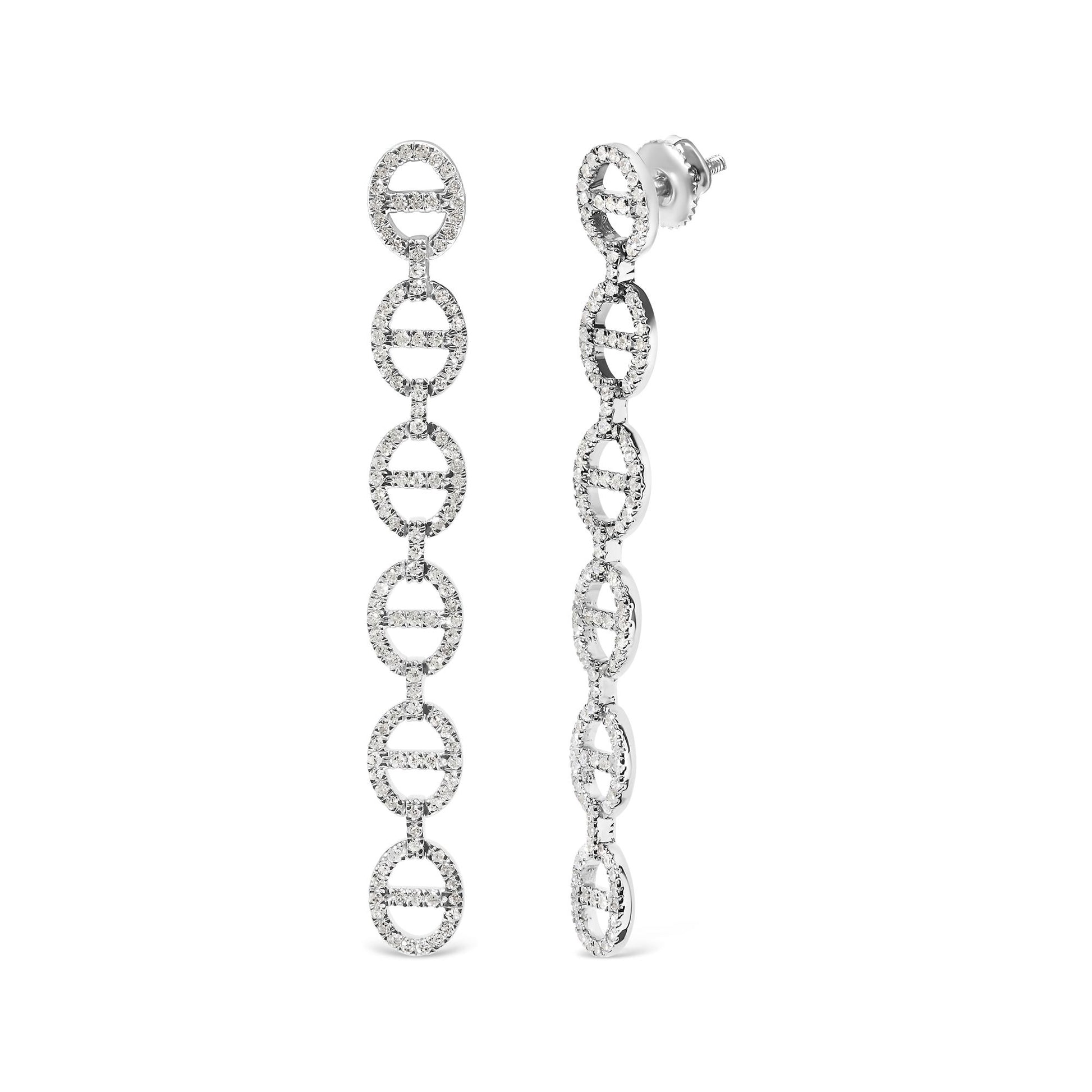 Close-up front and side view of long white earrings composed of linked oval shapes studded with round white gemstones in prong settings.