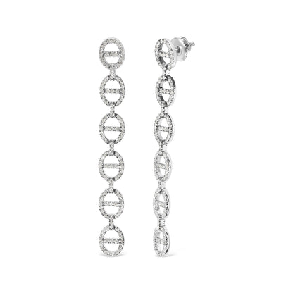 Close-up front and side view of long white earrings composed of linked oval shapes studded with round white gemstones in prong settings.