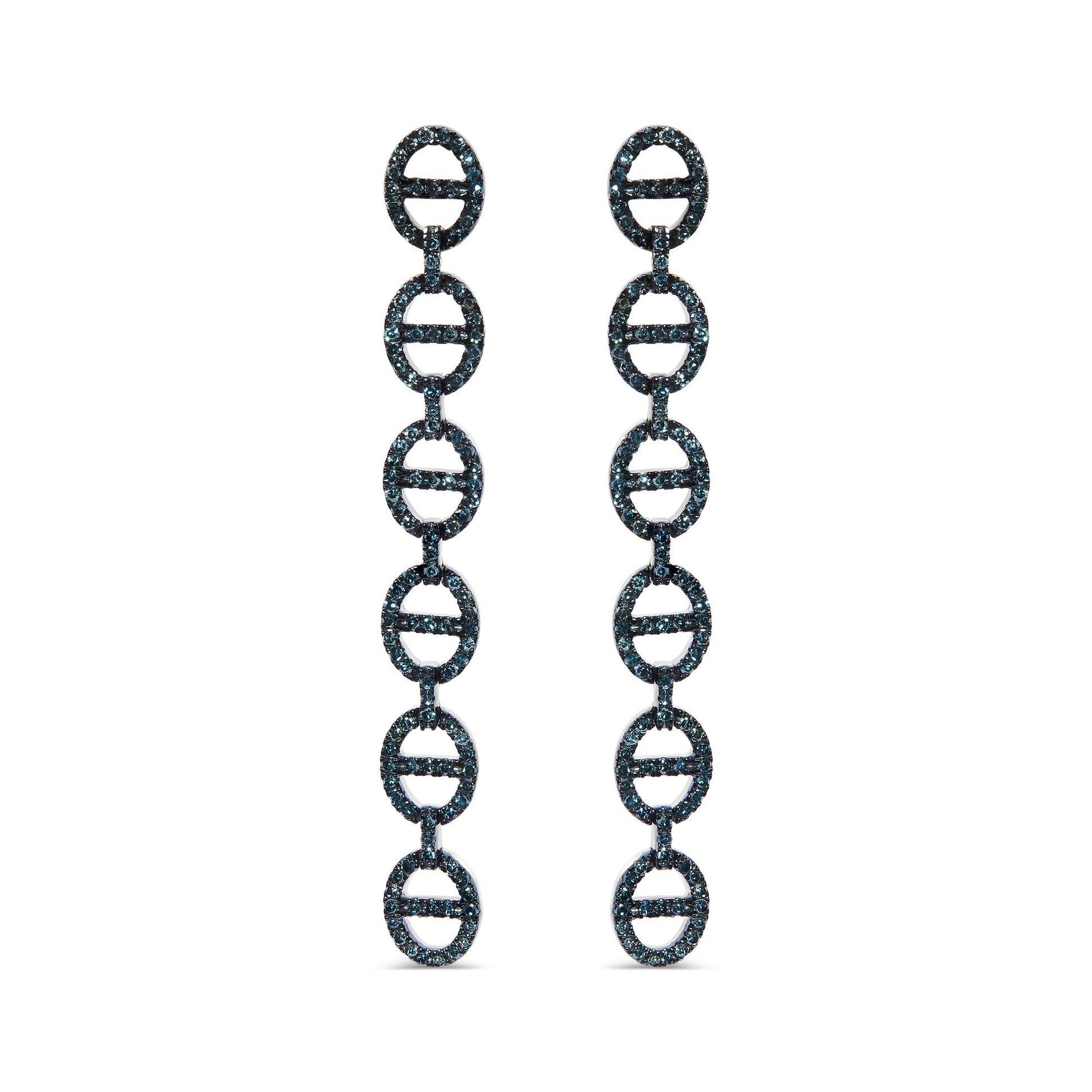 Front view of white metal drop earrings composed of linked oval shapes embellished with prong-set round blue gemstones, shown on a white background.