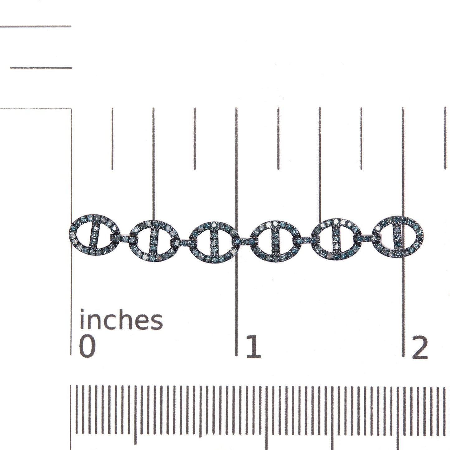 Close-up front view of white metal earrings with linked circular shapes encrusted in small round blue gemstones, shown on a scale.