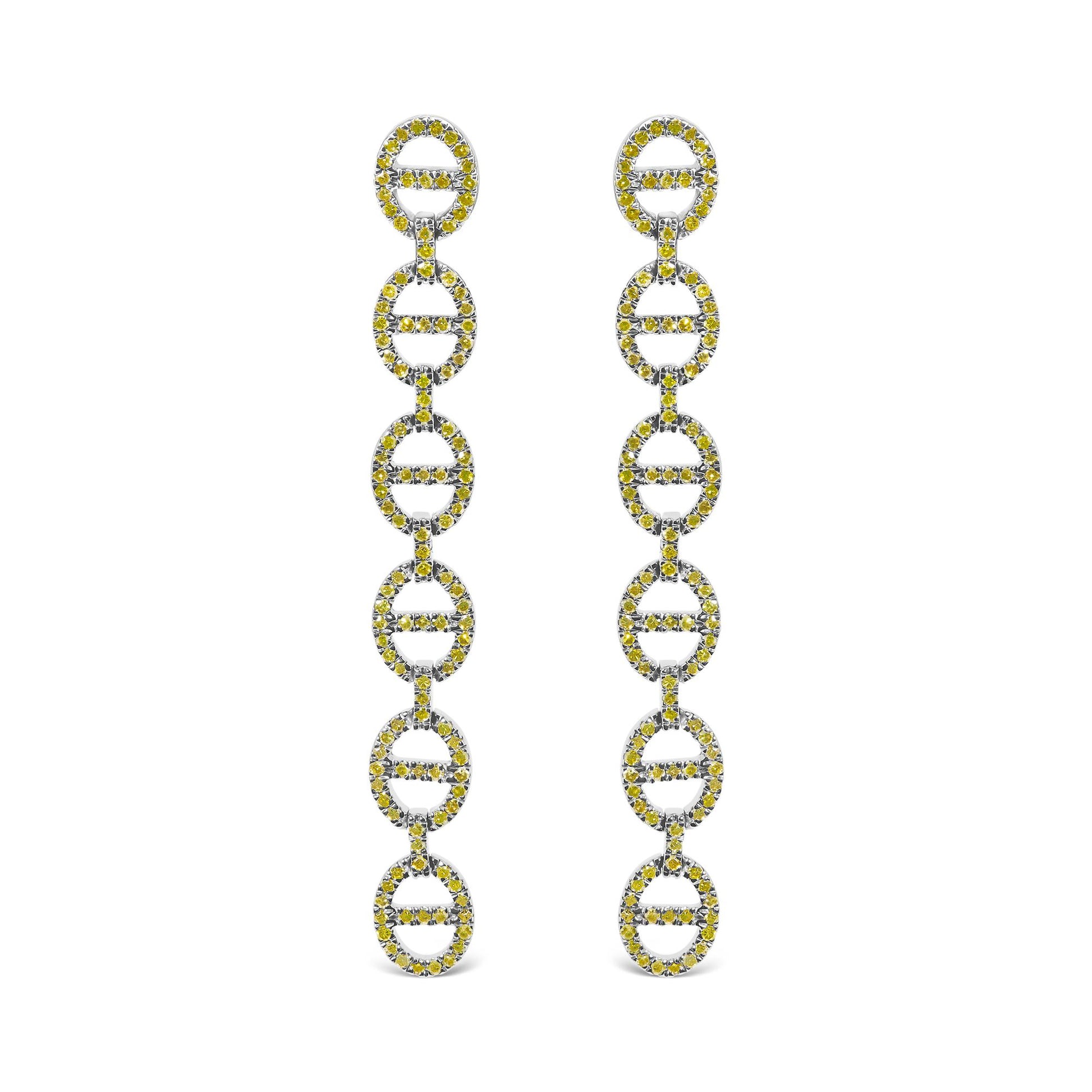 Close-up front view of white metal earrings with multiple linked oval shapes, each adorned with round yellow gemstones in prong settings.