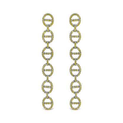 Close-up front view of white metal earrings with multiple linked oval shapes, each adorned with round yellow gemstones in prong settings.