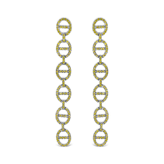 Close-up front view of white metal earrings with multiple linked oval shapes, each adorned with round yellow gemstones in prong settings.