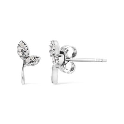 Close-up front and side view of a pair of white metal earrings shaped like two leaves, each leaf accented with multiple round white gemstones in prong settings, shown on a white background.