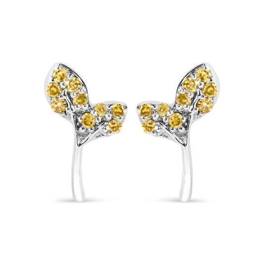 Close-up front view of white metal earrings adorned with multiple round yellow gemstones in prong settings, shown on a white background.