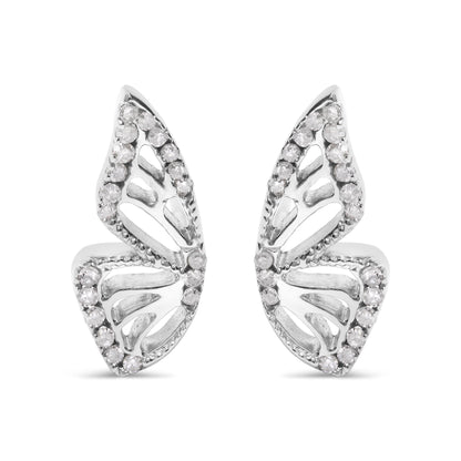 Close-up front view of a pair of white metal earrings shaped like stylized leaves, each adorned with round white gemstones in prong settings outlining the edges.