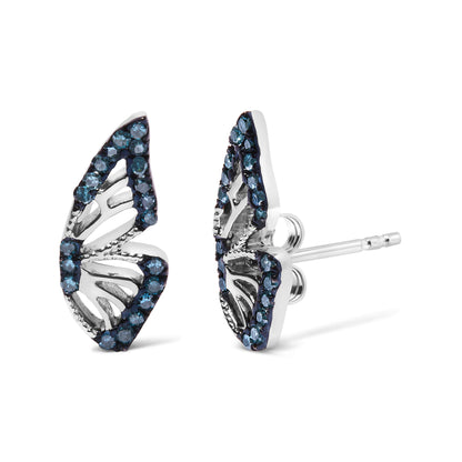Close-up front angle of a pair of white metal earrings with an open leaf-like design, adorned with round blue gemstones in prong settings. The earrings are shown on a white background.