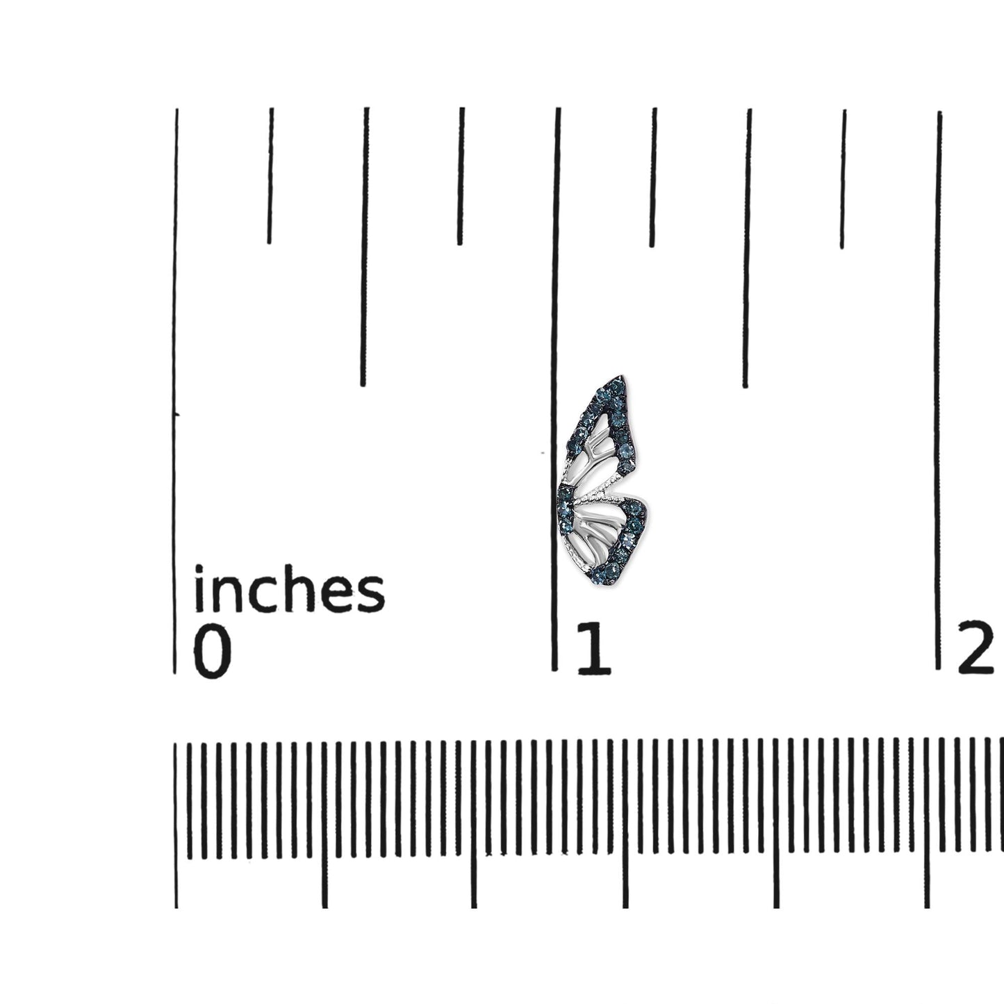Close-up front angle of a single white metal earring shaped like a wing, outlined with round blue gemstones in prong settings, shown on a scale for size reference.