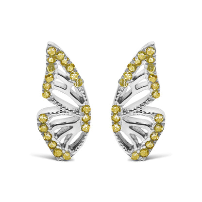 Close-up front view of a pair of white metal earrings shaped like leaves with openwork design, accented around the edges with round yellow gemstones in prong settings, shown on a white background.