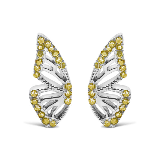 Close-up front view of a pair of white metal earrings shaped like leaves with openwork design, accented around the edges with round yellow gemstones in prong settings, shown on a white background.