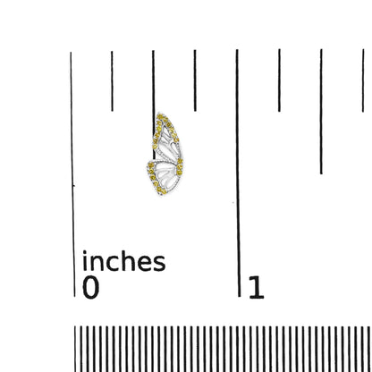 Close-up front view of a white metal butterfly-shaped earring adorned with yellow round gemstones in prong settings, shown on a ruler scale.