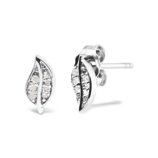 Pair of white metal earrings with a curved leaf shape, set with multiple round white gemstones in a prong setting, shown in a close-up angled side view.