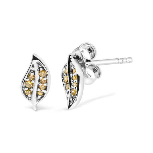 Pair of white metal leaf-shaped stud earrings with round yellow gemstones in prong settings, shown from a slightly angled front and side view.