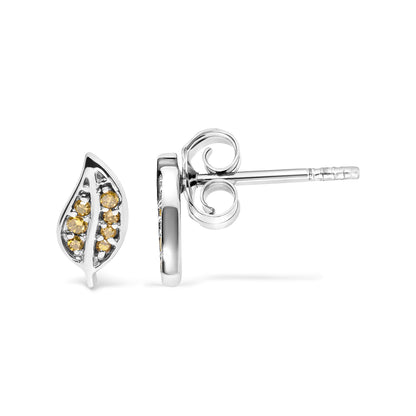 Close-up front and side view of white metal leaf-shaped stud earrings with prong-set round yellow gemstones.