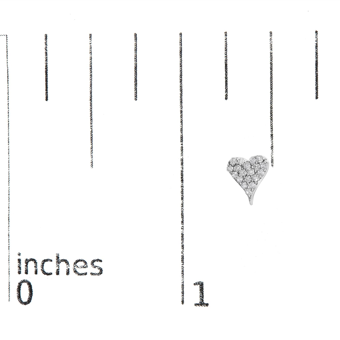 Heart-shaped white metal earring with round white gemstones in prong setting, shot from the front on a ruler for size reference.